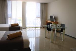 een hotelkamer met een bed en een bureau met een laptop bij Hotel Suites Bernini in Guadalajara