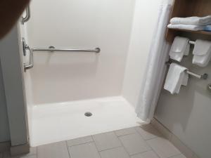 a bathroom with a shower with white towels at Microtel Inn & Suites by Wyndham Augusta/Riverwatch in Augusta