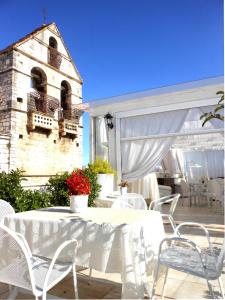 a white table and chairs on a patio at Palazzo Antica Via Appia in Bitonto