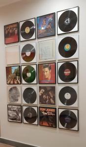 a bunch of cds are on a wall at Art & Jazz Hotel in Catania