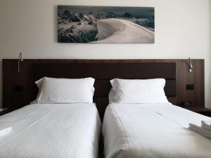 Gulta vai gultas numurā naktsmītnē Albergo Delle Alpi