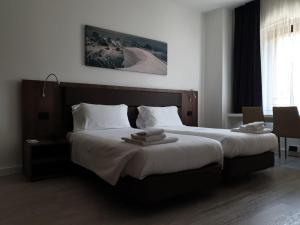 Posteľ alebo postele v izbe v ubytovaní Albergo Delle Alpi