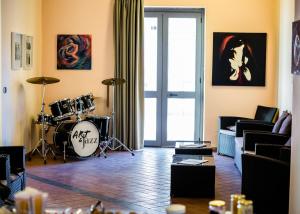 a living room with a drum set in a room at Art & Jazz Hotel in Catania