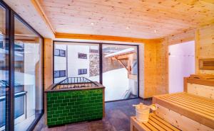ゲルロスにあるGaspingers Bergjuwelの緑のベンチと窓が備わる客室です。
