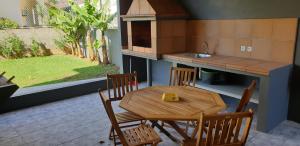 a kitchen with a wooden table and chairs and a sink at Casa da Lagoa in Calheta