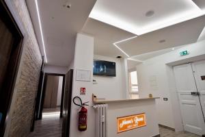 a hallway with a fire extinguisher in a building at Noemi's rooms Guest House in Rome