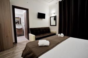 A bed or beds in a room at Noemi's rooms Guest House