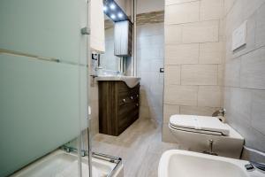 a bathroom with a toilet and a sink at Noemi's rooms Guest House in Rome