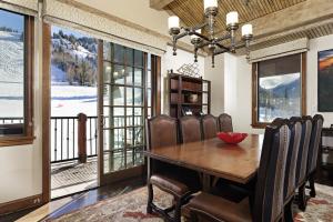 a dining room with a table and chairs and a balcony at The Ritz-Carlton Club, 3 Bedroom Penthouse 4301, Ski-in & Ski-out Resort in Aspen Highlands in Aspen
