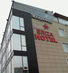 a building with a sign on the side of it at Eriza Boutique Hotel in Erzincan