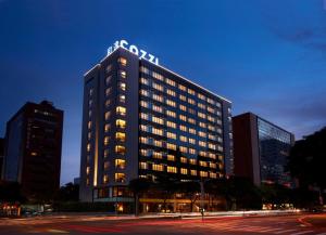 a tall building with a sign on top of it at Hotel COZZI Minsheng Taipei in Taipei