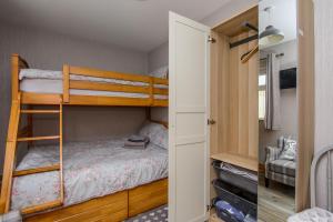a bedroom with two bunk beds and a closet at Annslea in Lisburn