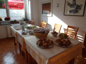 a table with plates of food on top of it at Fedrig Private Rooms & Apartment in Kobarid