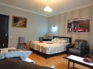a bedroom with a bed and a living room at Guest House, Old-Si in Tbilisi City