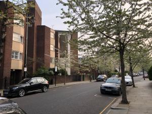 zwei Autos auf der Seite einer Stadtstraße geparkt in der Unterkunft Notting Hill Apartment in London