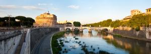 a bridge over a river in a city at Rome Services Porta Castello in Rome