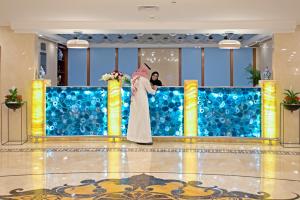 a bride standing on a stage in a hotel lobby at Le Bosphorus Hotel - Waqf Safi in Al Madinah