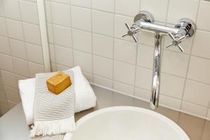 a bathroom with a white toilet and a sink at Wieshütten - fewo-badhindelang in Bad Hindelang