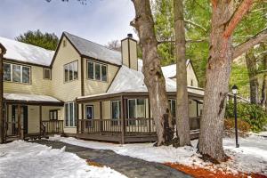 a house with a covered porch in the snow at Club Wyndham Shawnee Village in East Stroudsburg