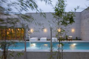a swimming pool in the middle of a house with lights at Hotel Wu Wei in Kortrijk