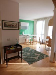 a living room with a table and a kitchen at Residenza San Pietro in Vicenza