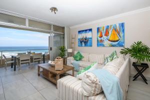 a living room with a view of the ocean at Sands Beach Breaks Luxury Beach Front Ballito in Ballito