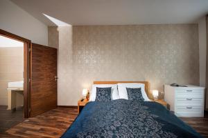 a bedroom with a large bed with two pillows at Apartment No. 11, Apartment House Oliver in Štrbské Pleso