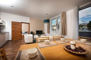 a kitchen and living room with a dining room table at Apartment No. 11, Apartment House Oliver in Štrbské Pleso