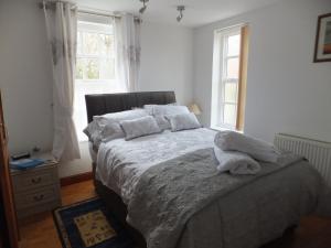 a bedroom with a bed and a window at West View Farm in Louth