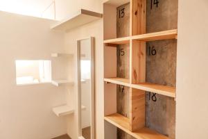 a walk in closet with wooden shelves and a mirror at Wild House Tarifa in Tarifa +37 photos