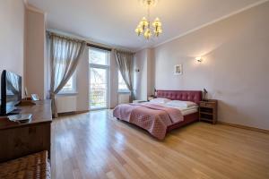 a bedroom with a bed and a television in it at DR Apartments - Kos in Sopot