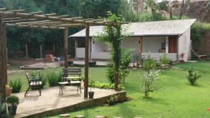 a garden with a bench and a house at pousada canarinho in Tiradentes +28 photos