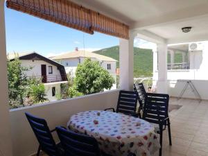 a table and chairs on a balcony with a view at Villa Nautica in Luštica