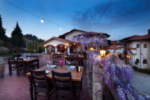 a restaurant with tables and chairs in front of a building at VINIFERA VINEYARDS HOTEL in Selcuk