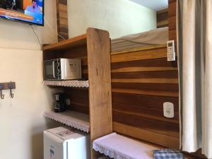 een stapelbed in een kamer met een magnetron bij Chalés Rose Pinon in São Sebastião