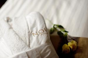 a white towel with the word novation on a bed at NOI Vitacura in Santiago