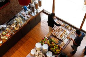 an overhead view of a buffet with people preparing food at NOI Vitacura in Santiago +36 photos