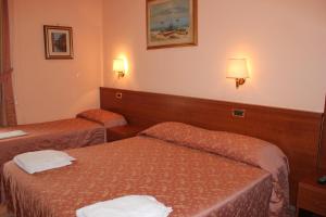 Postel nebo postele na pokoji v ubytování Hotel Aristotele