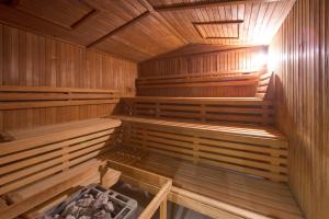 an empty wooden sauna with wooden floors and ceilings at Hotel Royal in Gliwice
