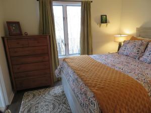a bedroom with a bed and a dresser and a window at The Homestead in Chester