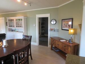 a living room with a table and a clock on the wall at The Homestead in Chester