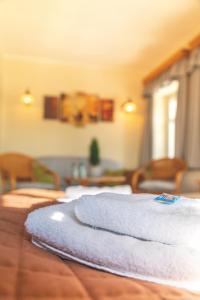 a pile of towels sitting on top of a wooden table at Prinz-Friedrich-August Baude in Sohland