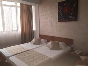 Postel nebo postele na pokoji v ubytování Hotel Flormang