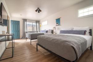 a bedroom with a bed and a chair in it at Spoke and Vine Motel in Palisade