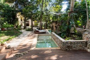 a pool in the middle of a yard with trees at Verde Morada in Valladolid