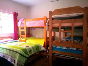 um quarto com 2 beliches e uma cama em Tinki Hostel em Cusco
