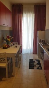 a kitchen with a table and a dining room with a table and a kitchen at Residenze Benedetto Croce in Bari