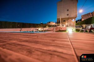 a tennis court in front of a building at night at Camino de Finisterre in Mazaricos