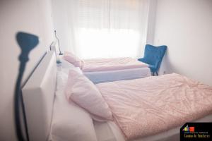 a bedroom with a bed and a chair and a window at Camino de Finisterre in Mazaricos +18 photos