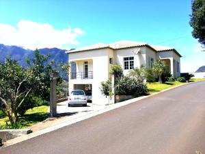 a white house on the side of a road at Casa do Vale in São Vicente